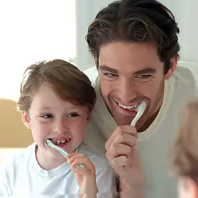 Father and son brushing teeth