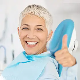 Dental patient giving a thumbs up
